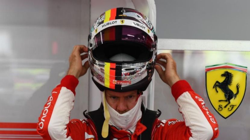 Vettel puts on his helmet
